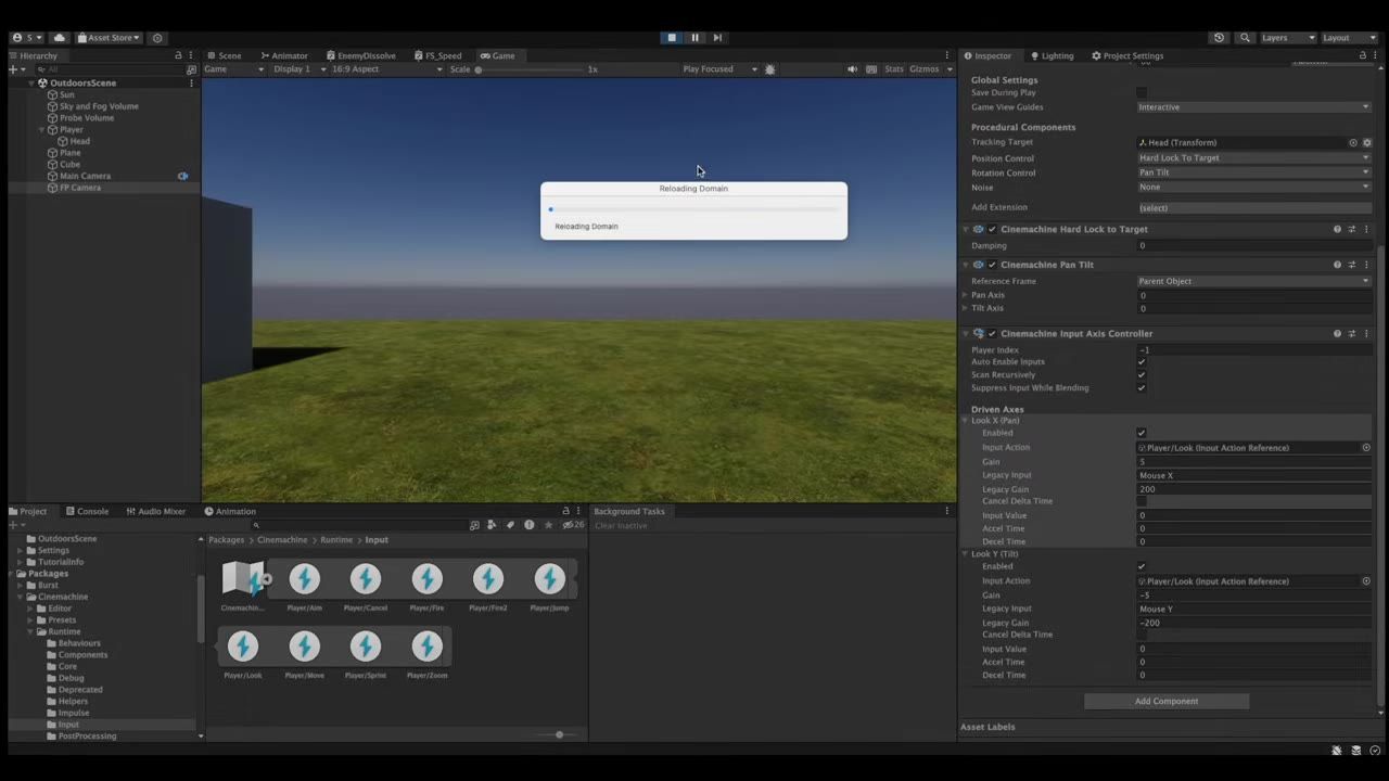 Unity editor with the Game view showing a grassy scene under a blue sky, a reloading dialog in the center, and camera/input settings open in the Inspector.