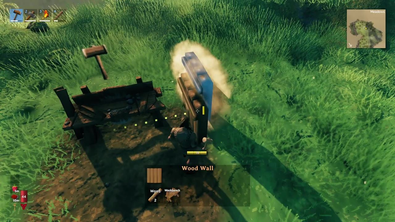 Player constructing a wooden wall near a crafting bench in a grassy outdoor space.