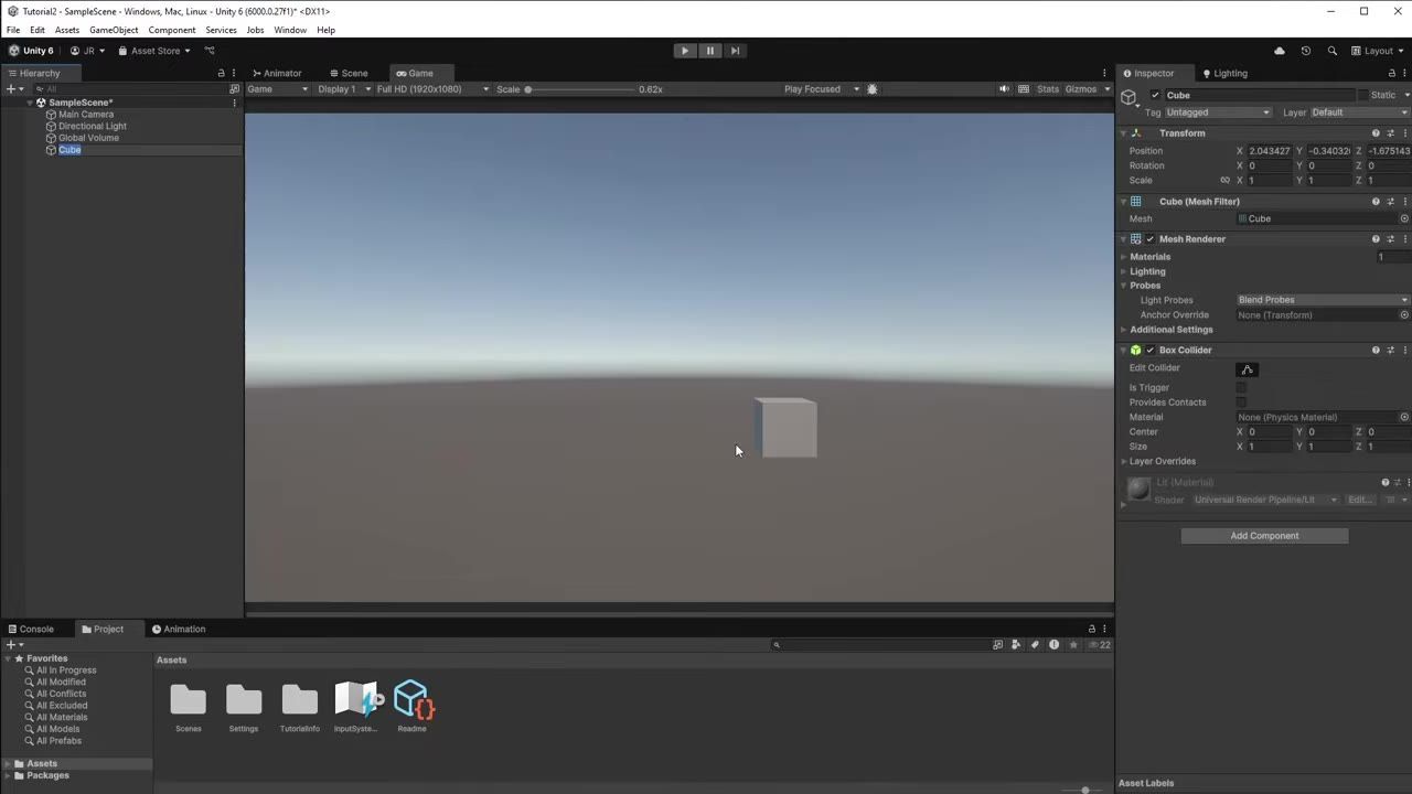 Unity editor with the Hierarchy on the left, the Game view in the center showing a gray cube on a flat ground plane, and the Inspector on the right for the selected Cube.