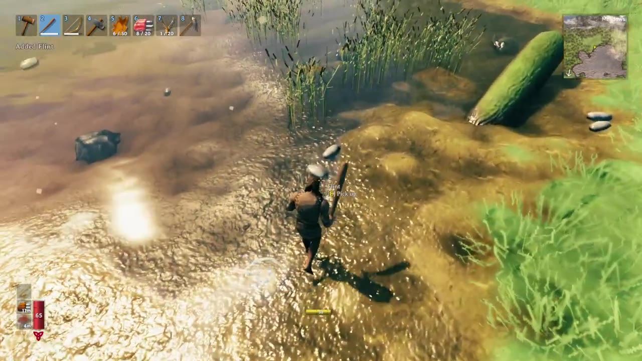 A character collecting flint near a stream surrounded by grass and rocks.