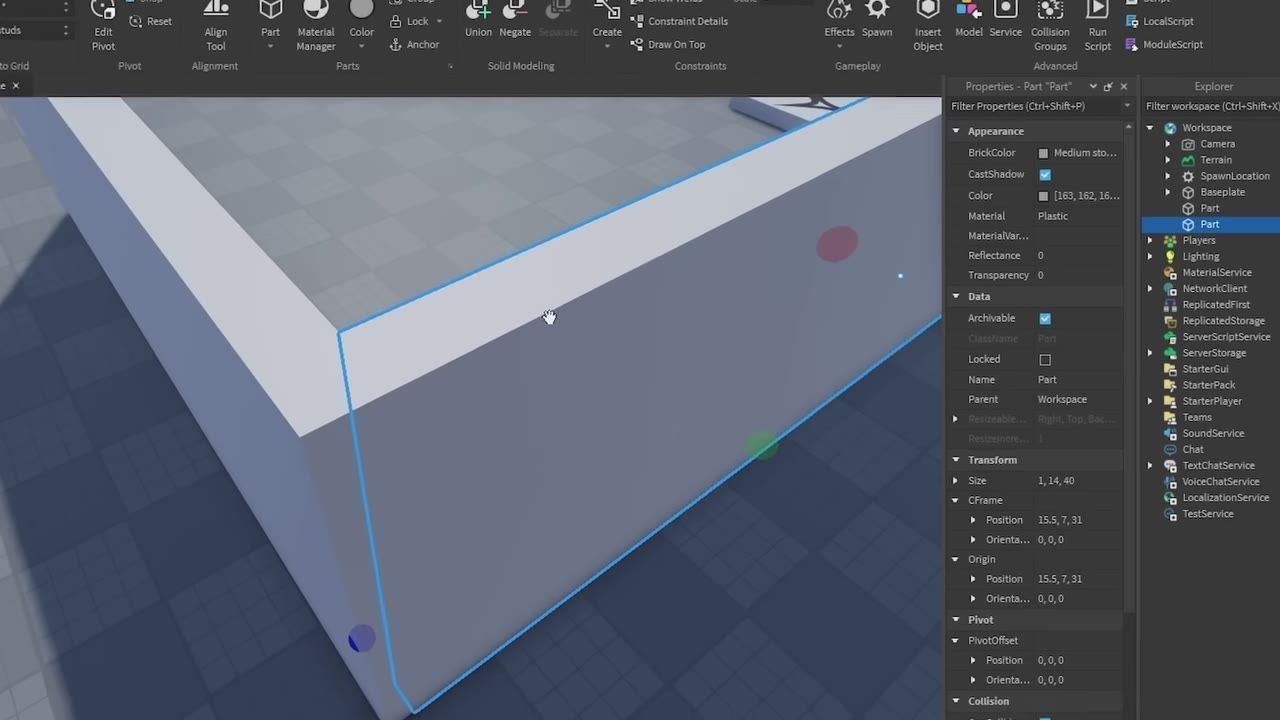 Roblox Studio shows a partially built gray structure in the 3D viewport with a selected wall part and the Properties panel open on the right.